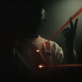 En mørkt belyst person iført en lys trøje står i tåge, mens flere røde lasersigtepunkter rammer brystet og skulderen. Personen holder hånden op med to fingre løftet i en gestus, hvilket skaber en dramatisk og intens stemning.